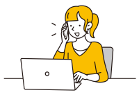 パソコンを見ながら電話する女性